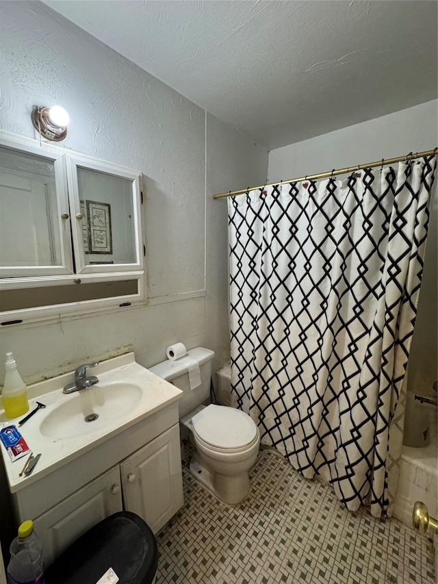 full bathroom featuring vanity, toilet, a textured ceiling, and shower / tub combo with curtain