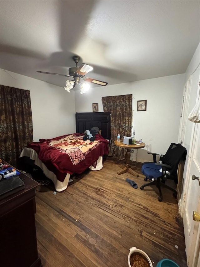 bedroom with ceiling fan and dark hardwood / wood-style flooring