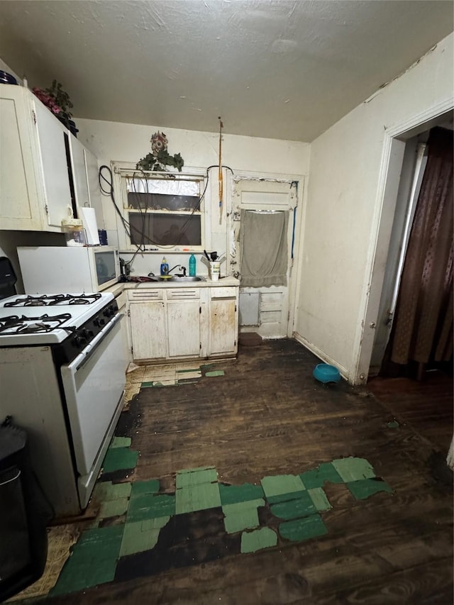 kitchen featuring white gas range and white cabinets