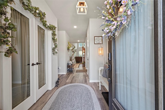 foyer entrance with wood-type flooring and french doors