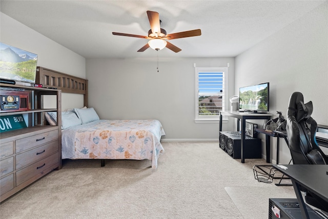 bedroom with ceiling fan and light carpet