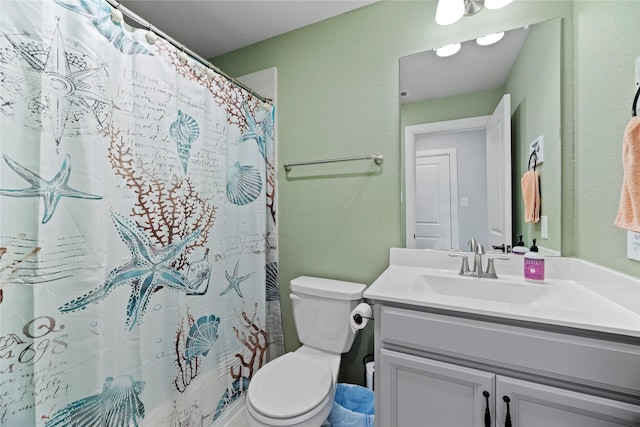 bathroom with toilet, walk in shower, and vanity