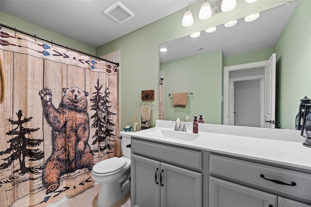 bathroom featuring toilet and vanity