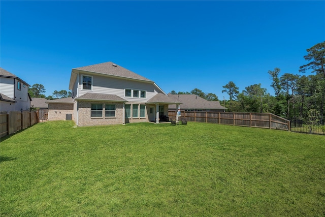 rear view of property with a yard