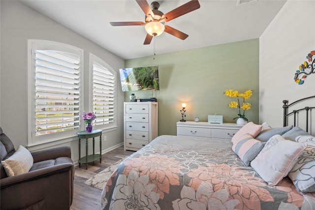 bedroom with dark wood-type flooring and ceiling fan