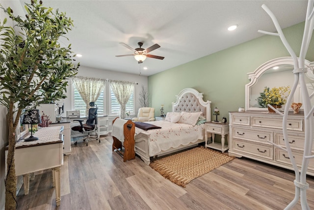 bedroom with light wood-type flooring and ceiling fan