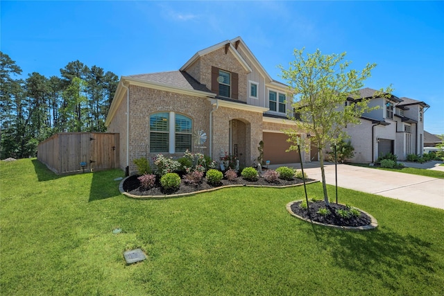 view of front of property featuring a front yard and a garage