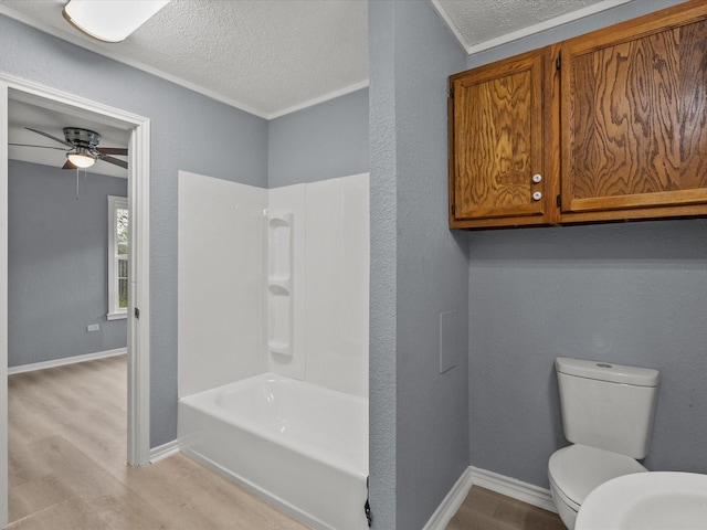 bathroom with crown molding, ceiling fan, hardwood / wood-style flooring, toilet, and shower / tub combination