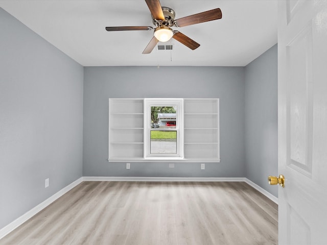 spare room featuring light wood-type flooring and ceiling fan