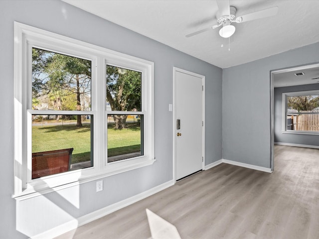 foyer entrance with light hardwood / wood-style floors and ceiling fan