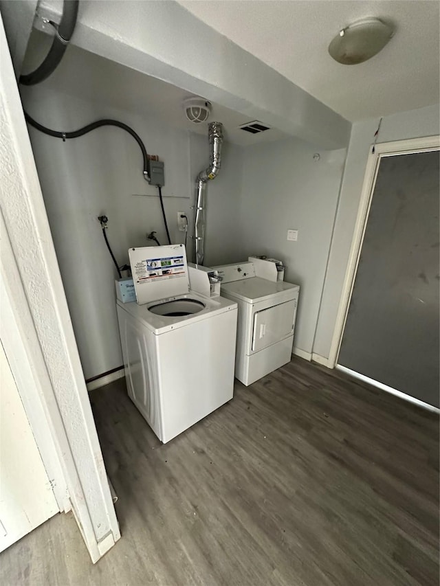 laundry room featuring dark wood-type flooring and washer and clothes dryer