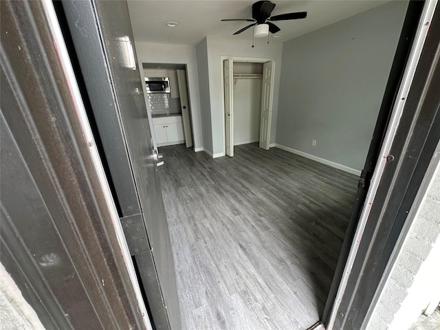 unfurnished bedroom featuring ceiling fan and wood-type flooring