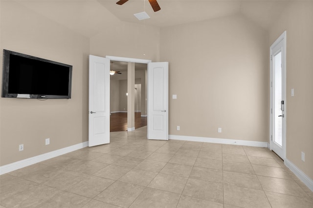 tiled spare room with ceiling fan and lofted ceiling