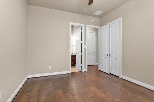 unfurnished bedroom featuring ceiling fan and dark hardwood / wood-style flooring