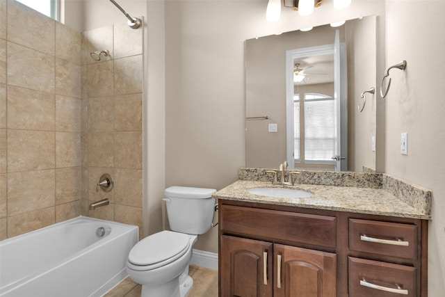 full bathroom featuring toilet, tiled shower / bath, ceiling fan, and vanity