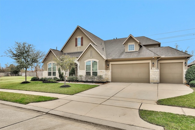 view of front of property with driveway, a garage, a shingled roof, stucco siding, and a front yard