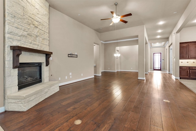 unfurnished living room featuring ceiling fan, hardwood / wood-style floors, and a fireplace