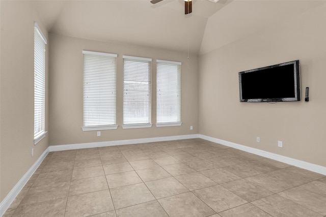 unfurnished room featuring vaulted ceiling, a wealth of natural light, ceiling fan, and light tile patterned floors