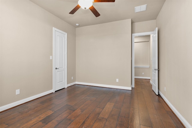 unfurnished bedroom featuring dark wood-type flooring and ceiling fan