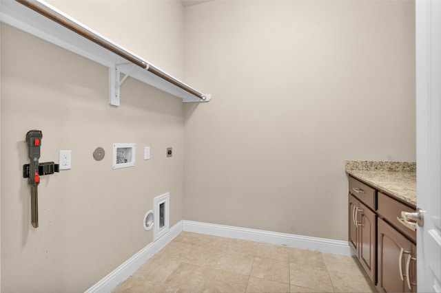 laundry room featuring electric dryer hookup, hookup for a washing machine, light tile patterned floors, gas dryer hookup, and cabinets