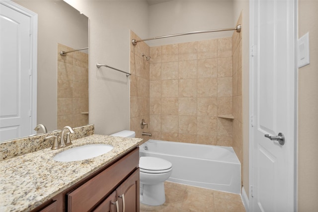 full bathroom featuring tile patterned floors, tiled shower / bath combo, vanity, and toilet