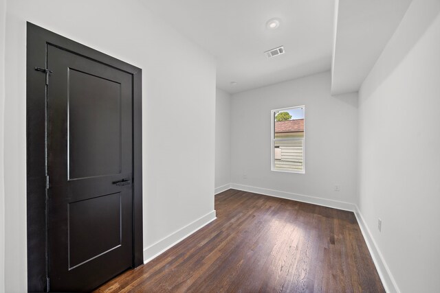 unfurnished room featuring dark hardwood / wood-style floors