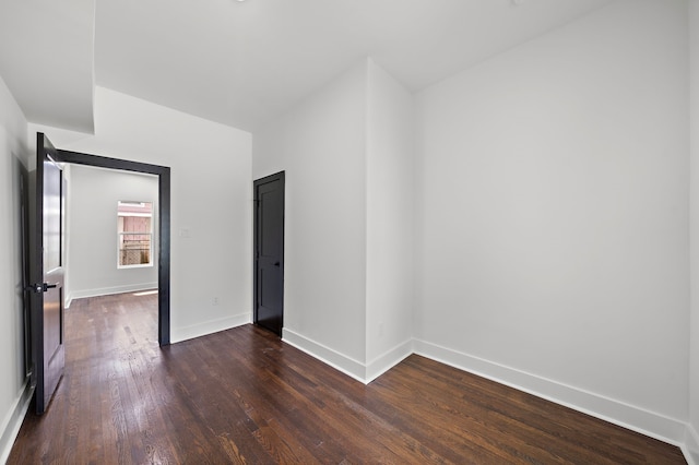 empty room with dark wood-type flooring