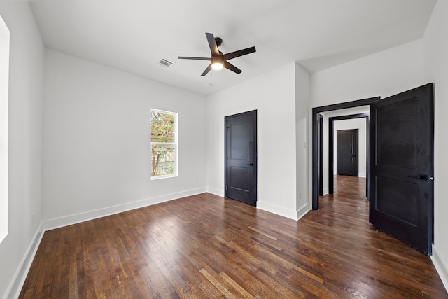 unfurnished bedroom featuring dark hardwood / wood-style floors and ceiling fan