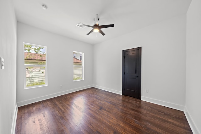 empty room featuring ceiling fan and dark hardwood / wood-style floors