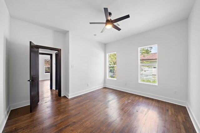 unfurnished room featuring ceiling fan and dark wood-type flooring