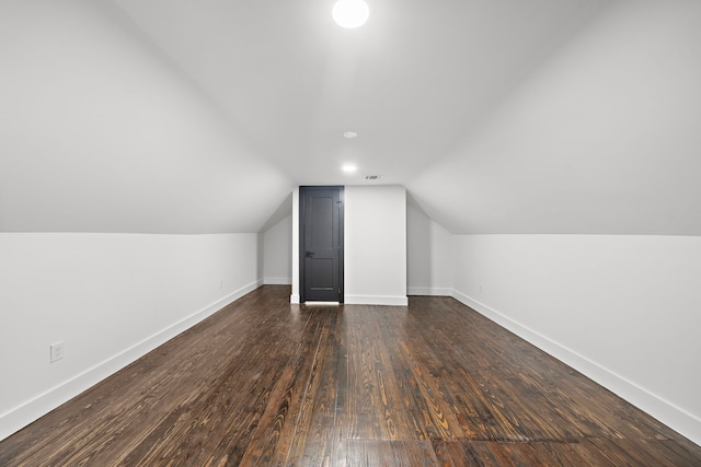 bonus room with dark hardwood / wood-style flooring and lofted ceiling