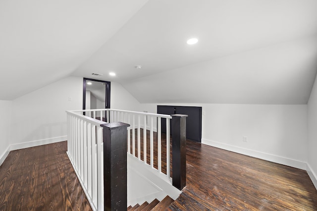 additional living space featuring dark hardwood / wood-style flooring and vaulted ceiling