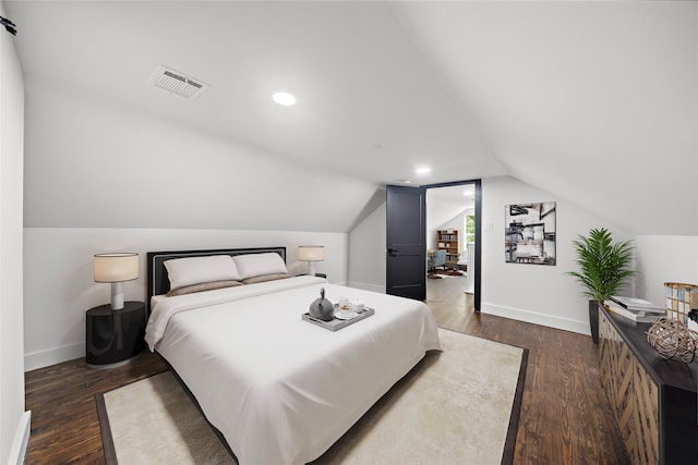 bedroom featuring dark hardwood / wood-style flooring and lofted ceiling