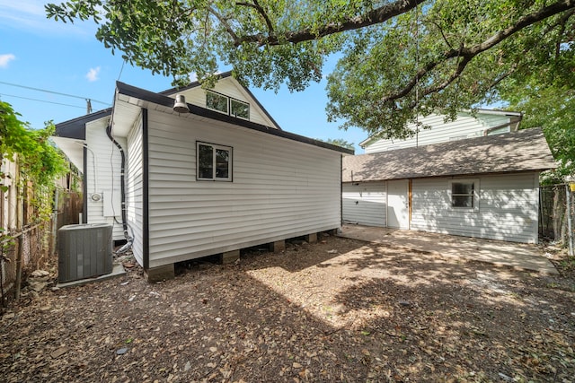 back of house with cooling unit and an outdoor structure