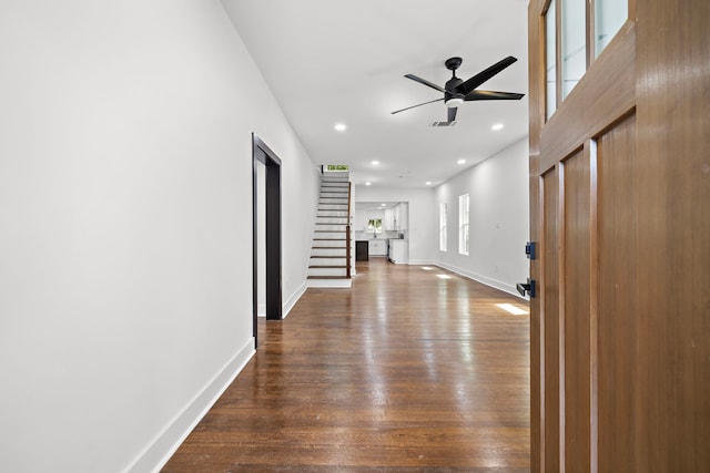 hallway with hardwood / wood-style floors