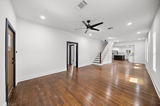 unfurnished living room with ceiling fan and dark hardwood / wood-style flooring