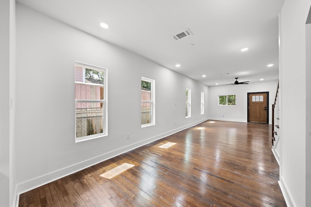 spare room with ceiling fan, dark hardwood / wood-style floors, and a healthy amount of sunlight