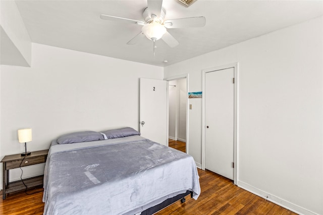 bedroom featuring hardwood / wood-style floors, a ceiling fan, and baseboards