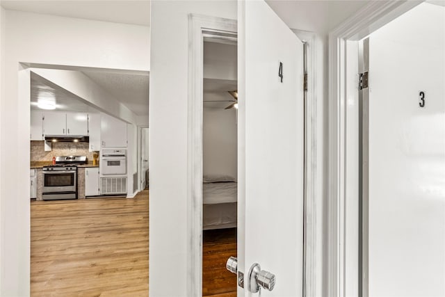 corridor featuring light wood finished floors