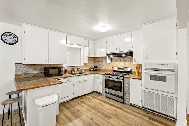 kitchen with white cabinets, white appliances, and sink