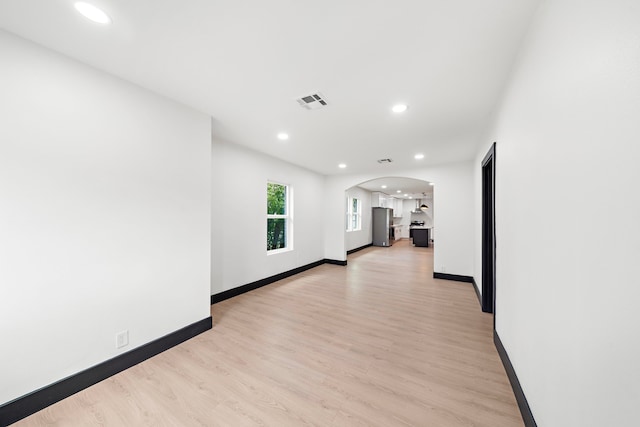 corridor with light hardwood / wood-style floors