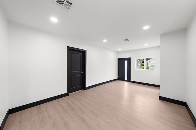 unfurnished room with light wood-type flooring