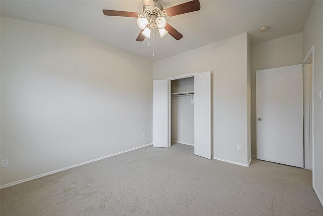 unfurnished bedroom featuring ceiling fan, a closet, and light carpet