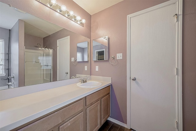 bathroom featuring vanity, an enclosed shower, and wood-type flooring