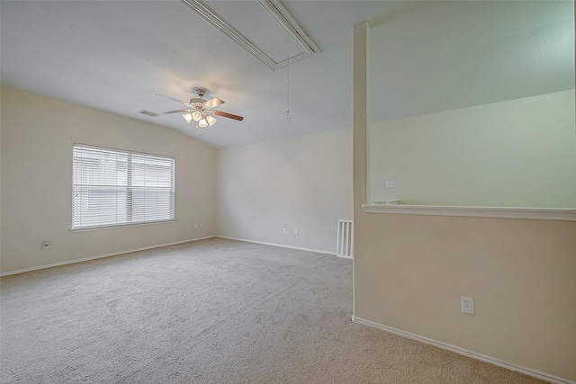 spare room featuring lofted ceiling and light colored carpet