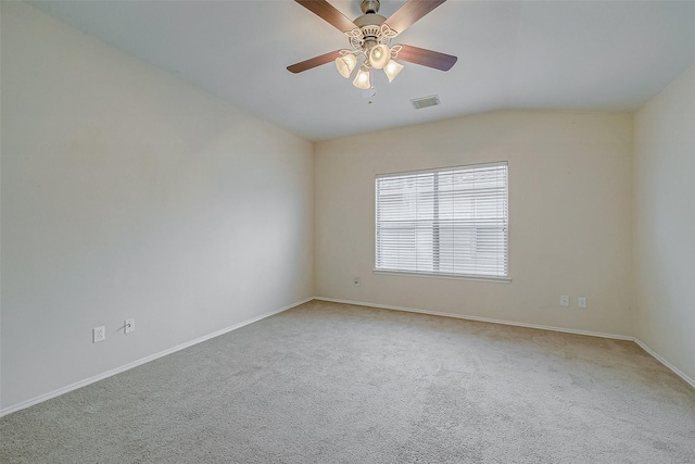 carpeted spare room with vaulted ceiling and ceiling fan