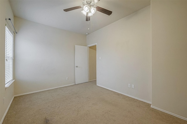 carpeted empty room featuring ceiling fan