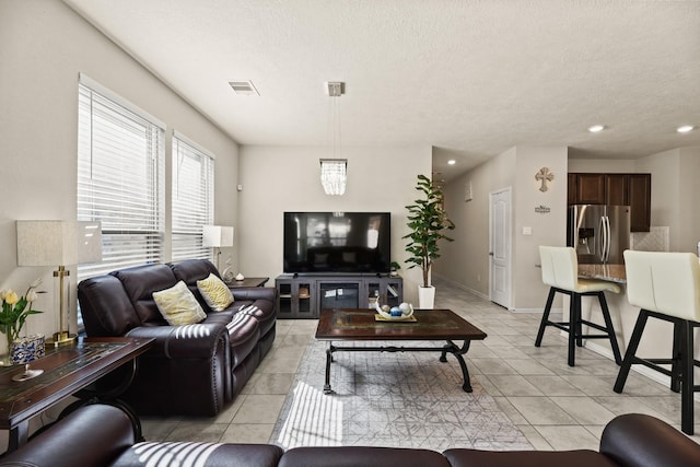 tiled living room with a textured ceiling