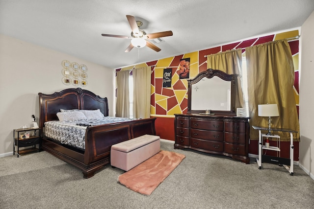 carpeted bedroom featuring ceiling fan and a textured ceiling