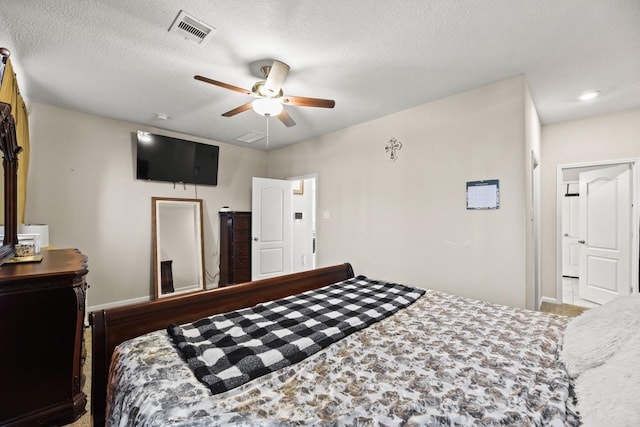 bedroom with a textured ceiling and ceiling fan